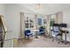 Bright home office with vaulted ceiling, two windows, desk, and two blue chairs at 1429 Noel Ne Dr, Brookhaven, GA 30319