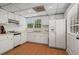 Bright, classic kitchen with white appliances, ample counter space, and a patterned ceiling at 1429 Noel Ne Dr, Brookhaven, GA 30319