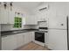Clean kitchen with white cabinets, appliances, and countertops, offering a modern and functional space at 1429 Noel Ne Dr, Brookhaven, GA 30319