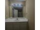 Bathroom with a large mirror, ample lighting, and white cabinetry at 1794 Fielding Way, Hampton, GA 30228