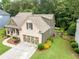 Aerial side view of the home, showing the well-maintained lawn, and landscaping at 2059 Ivey Chase Dr, Dacula, GA 30019