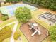 Aerial view of the community amenities including tennis courts, basketball court and playground surrounded by green grass at 2059 Ivey Chase Dr, Dacula, GA 30019