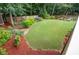 Beautiful backyard with lush green lawn, garden beds, and a wooden privacy fence at 2059 Ivey Chase Dr, Dacula, GA 30019