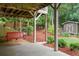 Backyard patio featuring a red swing, wooden shed, and landscaped garden at 2059 Ivey Chase Dr, Dacula, GA 30019
