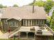 Aerial view of the backyard with deck, patio, and lush green lawn at 2059 Ivey Chase Dr, Dacula, GA 30019