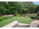View of the home's grassy backyard, featuring landscaped flower beds and privacy fence at 2059 Ivey Chase Dr, Dacula, GA 30019