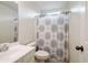 Clean bathroom with white vanity, toilet, and patterned shower curtain at 2059 Ivey Chase Dr, Dacula, GA 30019