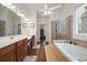 Bright bathroom featuring double sinks, a soaking tub with tiled surround, and a separate glass shower at 2059 Ivey Chase Dr, Dacula, GA 30019