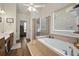 Bright bathroom featuring double sinks, a soaking tub with tiled surround, and a separate glass shower at 2059 Ivey Chase Dr, Dacula, GA 30019