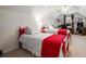 Bright bedroom featuring two red twin beds, neutral carpeting, and a ceiling fan at 2059 Ivey Chase Dr, Dacula, GA 30019