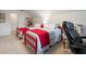 Spacious bedroom featuring two twin beds with bright red accents and a comfortable office chair at 2059 Ivey Chase Dr, Dacula, GA 30019