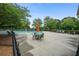 Community pool area with seating, umbrellas, and lush landscaping at 2059 Ivey Chase Dr, Dacula, GA 30019