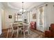 Inviting dining area with elegant wainscoting, decorative rug, and plenty of natural light from bright windows at 2059 Ivey Chase Dr, Dacula, GA 30019