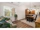 Bright dining area featuring hardwood floors, vaulted ceilings, and views of the backyard at 2059 Ivey Chase Dr, Dacula, GA 30019