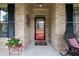 Inviting front door with decorative details, flanked by windows and black shutters at 2059 Ivey Chase Dr, Dacula, GA 30019