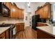 Well-lit kitchen with wood cabinets, granite countertops, and stainless steel appliances at 2059 Ivey Chase Dr, Dacula, GA 30019