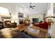 Open living room with vaulted ceiling, brick fireplace, hardwood floors, and lots of natural light at 2059 Ivey Chase Dr, Dacula, GA 30019