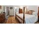 Spacious main bedroom with a four-poster bed, hardwood floors, and neutral decor at 2059 Ivey Chase Dr, Dacula, GA 30019