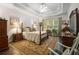 Large main bedroom featuring a tray ceiling, hardwood floors, and furniture at 2059 Ivey Chase Dr, Dacula, GA 30019