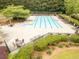 Community pool featuring lounge chairs, tables, and mature landscaping at 2059 Ivey Chase Dr, Dacula, GA 30019
