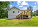 Backyard view of a white home with a wooden deck and stairs at 4430 Lamar Dr, Douglasville, GA 30134