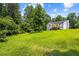 Expansive backyard with a view of the home featuring a deck and grassy landscape at 4430 Lamar Dr, Douglasville, GA 30134