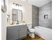 Stylish bathroom features a gray vanity, a well-lit mirror, contemporary fixtures, and a shower-tub combo with tile surround at 4430 Lamar Dr, Douglasville, GA 30134