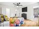 Cozy bedroom featuring a colorful floral bedspread, modern black dresser, light-toned wood flooring, and ensuite bathroom at 4430 Lamar Dr, Douglasville, GA 30134