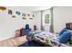 Fun bedroom with superhero-themed decor, plush blue rug, light-toned wood flooring, and natural light at 4430 Lamar Dr, Douglasville, GA 30134