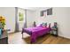 Bright bedroom featuring a window, sleek hardwood floors, and vibrant decor at 4430 Lamar Dr, Douglasville, GA 30134