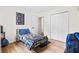 bedroom features a super hero bedspread, light-toned wood flooring, and ample closet space for storage at 4430 Lamar Dr, Douglasville, GA 30134