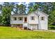 Charming renovated home with a bright exterior, inviting porch, and manicured lawn in a lush, green setting at 4430 Lamar Dr, Douglasville, GA 30134