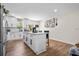 Bright kitchen features a central island with bar seating, white cabinets, stainless appliances, and open concept floorplan at 4430 Lamar Dr, Douglasville, GA 30134