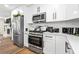 Modern kitchen showcasing white cabinetry, stainless steel appliances, and contemporary finishes at 4430 Lamar Dr, Douglasville, GA 30134