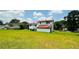 Spacious backyard featuring well-maintained lawn and two-story home with an elevated back deck at 472 Opel St, Riverdale, GA 30274