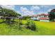 Large backyard with mature trees, green grass, and a framed garden area near the house at 472 Opel St, Riverdale, GA 30274