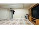 Finished basement with vintage tile flooring and a vintage wood entertainment center at 472 Opel St, Riverdale, GA 30274