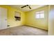 Bright bedroom features yellow walls and neutral carpet at 472 Opel St, Riverdale, GA 30274
