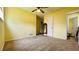 Spacious bedroom features yellow walls and neutral carpet at 472 Opel St, Riverdale, GA 30274