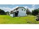 Exterior shot of the home showing the back and side, surrounded by a green lawn at 472 Opel St, Riverdale, GA 30274