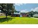Split-level home with a carport, set on a green lawn under a blue sky at 472 Opel St, Riverdale, GA 30274