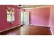 Pink living room with hardwood floors and a bright window at 472 Opel St, Riverdale, GA 30274