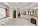Bright bathroom features a soaking tub, separate shower, and double vanity with decorative mirrors at 4720 Cliffside Ct, Marietta, GA 30067