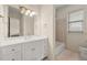Neutral bathroom featuring white vanity with drawers, large mirror, bathtub, and a window for natural light at 4720 Cliffside Ct, Marietta, GA 30067