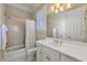 Bright bathroom featuring a shower-tub, tiled walls, and white vanity with gold fixtures at 4720 Cliffside Ct, Marietta, GA 30067