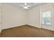 Open bedroom with neutral walls, a window for natural light, and a ceiling fan at 4720 Cliffside Ct, Marietta, GA 30067