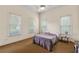 Bedroom featuring neutral-toned walls, three windows for ample natural light, and a ceiling fan for comfortable airflow at 4720 Cliffside Ct, Marietta, GA 30067