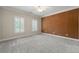 Large bedroom with brown accent wall, two bright windows and carpet at 4720 Cliffside Ct, Marietta, GA 30067