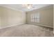 Spacious bedroom with plush carpeting, crown molding, a ceiling fan, and natural light from the window at 4720 Cliffside Ct, Marietta, GA 30067