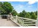 View from the deck of the beautifully landscaped backyard with grilling area and decorative white railing at 4720 Cliffside Ct, Marietta, GA 30067